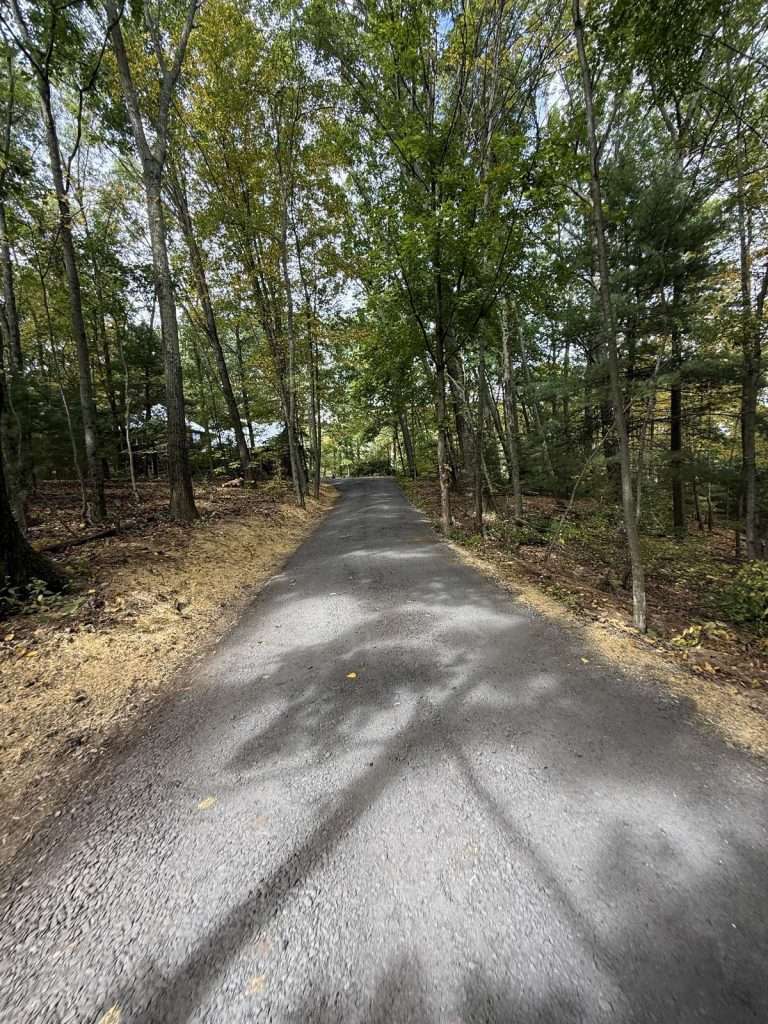 Crowned gravel driveway in Pine Plains NY with a drainage swale cut along the edge